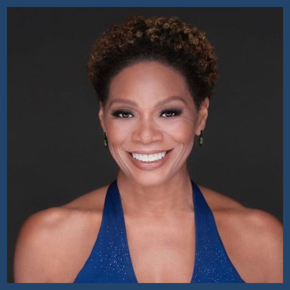 Stephanie Pope Lofgren in a blue halter dress, smiling warmly against a dark background.